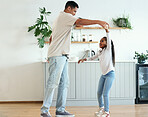 Dance, playful and father and daughter bonding, teaching a move and enjoying quality time. Love, help and dad dancing with a girl daughter, playing and being crazy with happiness in the kitchen