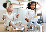 Girl children, kitchen and drums with pot in black family home, happiness and comic bonding on holiday. Young kids, sisters and happy for comedy music, joke and excited in morning for playful friends