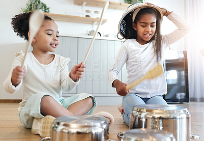Buy stock photo Girl children, kitchen and drums with pot in black family home, happiness and comic bonding on holiday. Young kids, sisters and happy for comedy music, joke and excited in morning for playful friends