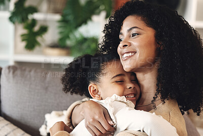 Buy stock photo Black family, love and hug by girl and mother on a sofa, happy and relax in their home together. Mom, daughter and embrace on a couch, cheerful and content while sharing a sweet moment of bonding
