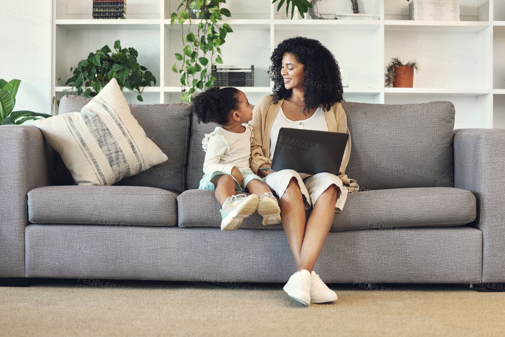 Buy stock photo Child, mother and laptop in family home living room for remote work, online education and wifi. Happy woman and girl kid talking on couch with internet for learning, games and watch movies to relax
