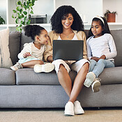 Family, video game and online gaming on home sofa with a pregnant mother  and daughter on a living room couch together while happy and having fun.  Woman and girl kid together for