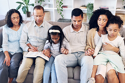Buy stock photo Religious, religion and family praying together in a home or house and praise God for peace, calm and soul. Gratitude, spiritual and people with hope and pray for forgiveness sitting on couch or sofa