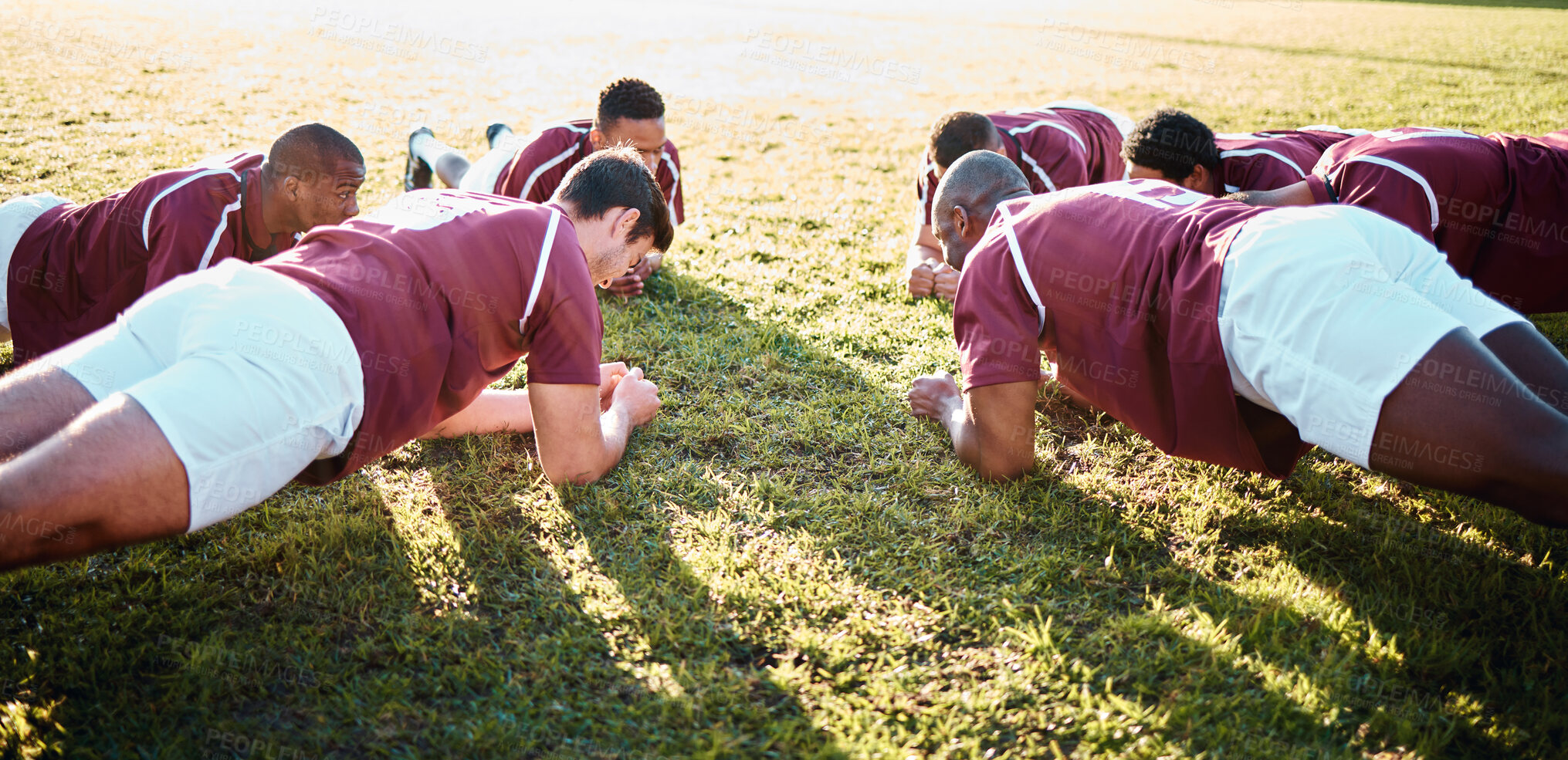 Buy stock photo Man, team and plank on grass field for sports training, fitness and collaboration in the outdoors. Group of sport rugby players in warm up exercise together for teamwork preparation, match or game