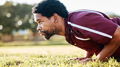 Buy stock photo Sports, workout and man doing a push up on the field for training or practice before a game. Fitness, health and African male athlete doing a warm up exercise before a match by a grass stadium.
