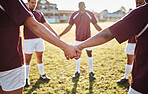 Man, team and holding hands for sports motivation, collaboration or coordination on grass field. Group of men huddle touching hand in circle for teamwork, community or sport strategy for outdoor game