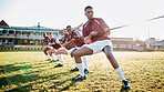 Sports, teamwork and tug of war, men at fitness training and practice for competition or game on field. Workout, collaboration and team pulling rope, working together in match for power and strength