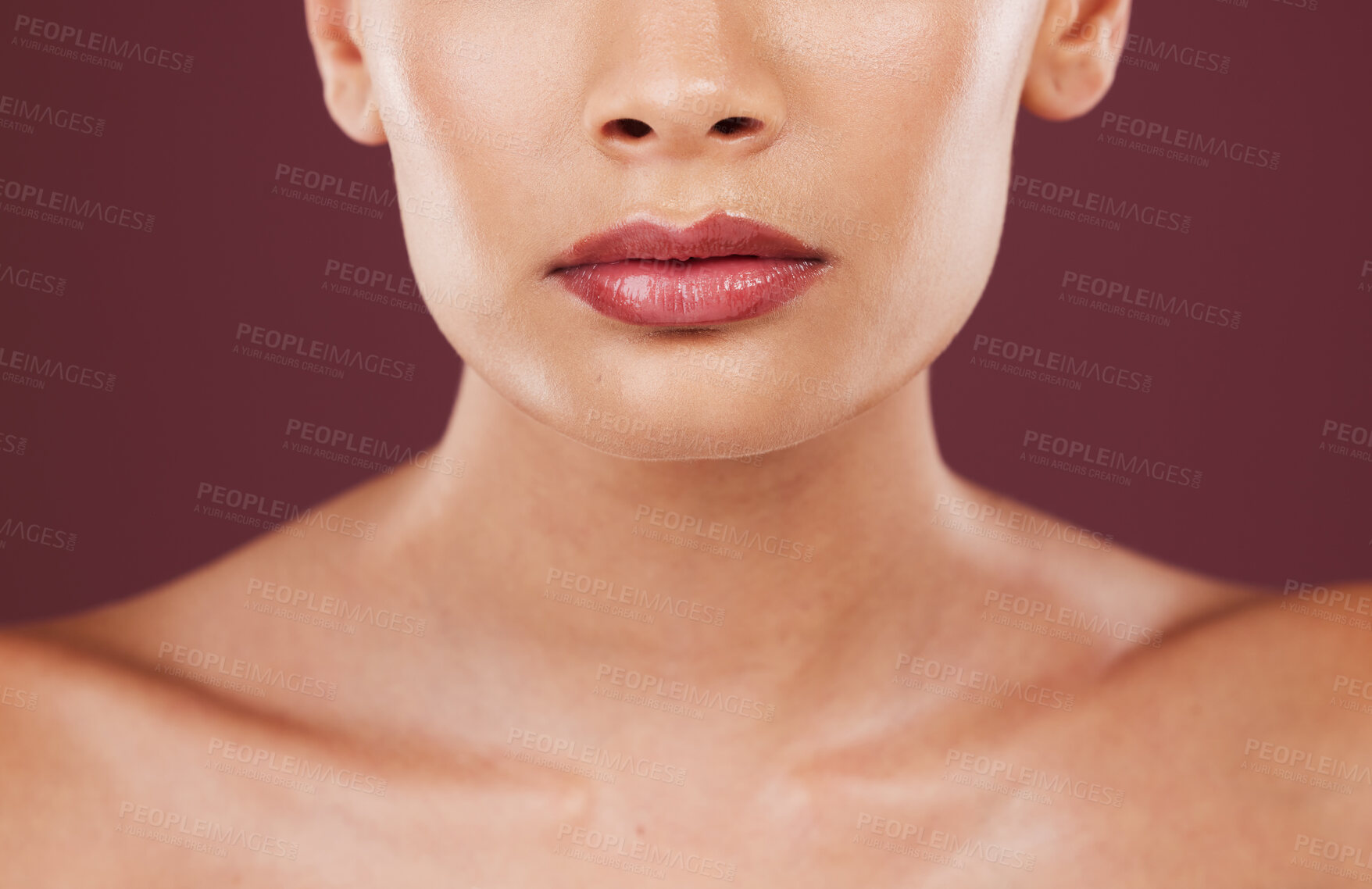 Buy stock photo Lips, face makeup and beauty of woman in studio isolated on a red background. Skincare dermatology, lipstick cosmetics and female model with beautiful, glowing or healthy skin after facial treatment.