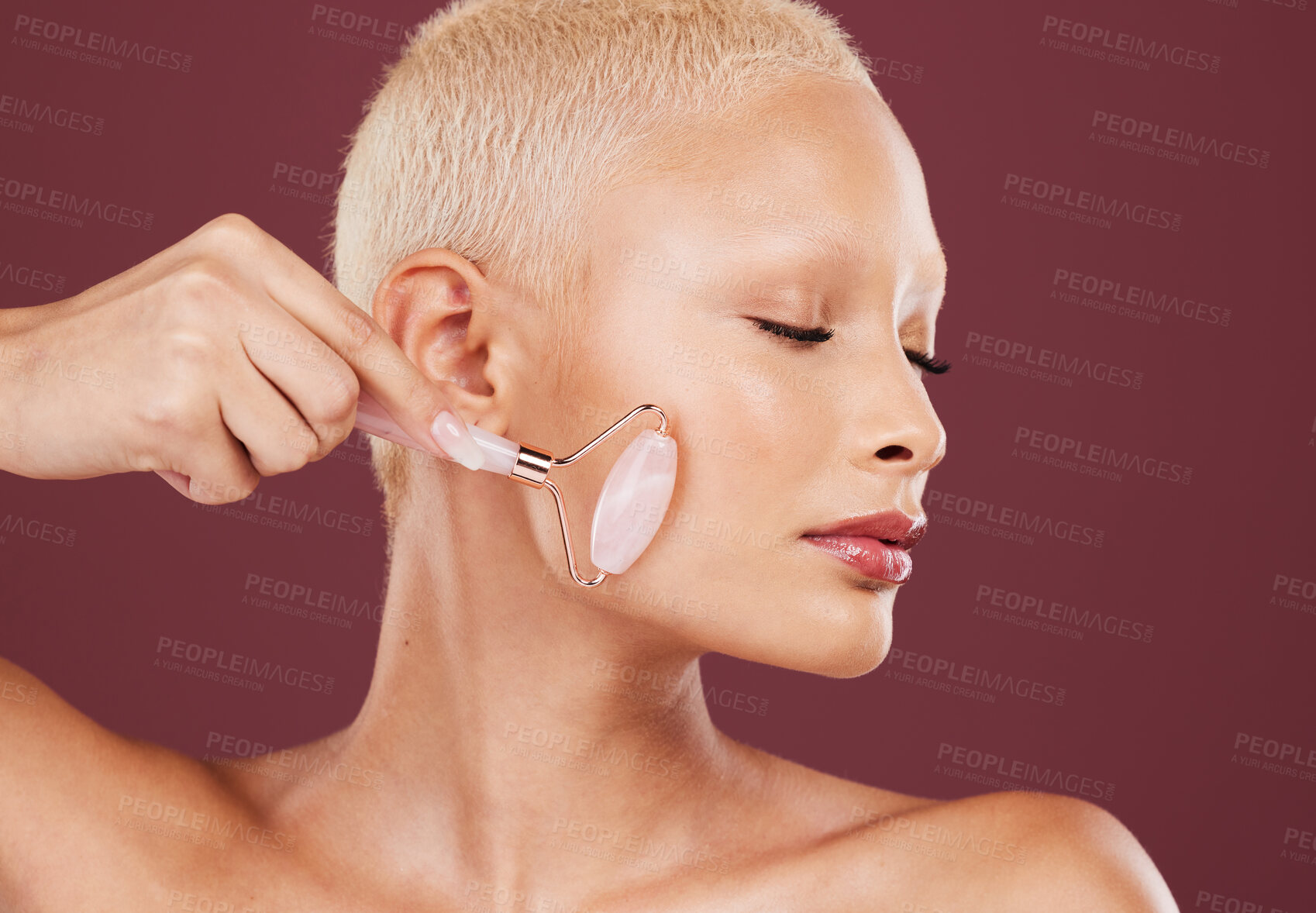 Buy stock photo Beauty, skincare and woman with facial roller, cosmetics and luxury salon treatment on studio background. Makeup, female and lady with confidence, rose quartz and wellness with heathy and smooth soft