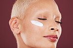 Eyes closed, face cream and beauty skincare of woman in studio isolated on red background. Dermatology, cosmetics and young female model with lotion, creme or moisturizer product for facial treatment