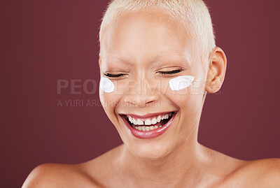 Buy stock photo Face cream, smile and beauty skincare of woman in studio isolated on a red background. Dermatology aesthetic, cosmetics and happy model laughing with funny facial lotion, creme and moisturizer.