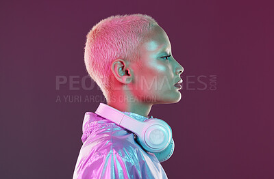 Buy stock photo Cyberpunk headphones, black woman and fashion in studio, holographic beauty and vaporwave clothes. Futuristic model, young gen z and listening to music with neon aesthetic, audio technology and face
