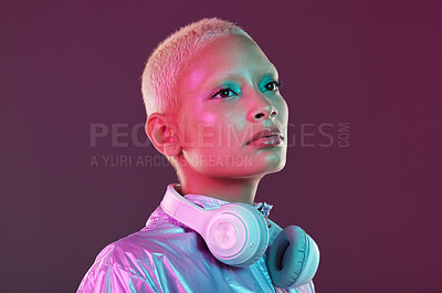 Buy stock photo Cyberpunk fashion, black woman and headphones in studio, holographic clothes and vaporwave style. Futuristic model, young gen z and listening to music with retro aesthetic, audio technology and neon