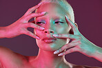 Neon makeup, woman with hands in face, skincare and lights for creative advertising on studio background. Cyberpunk, product placement and model isolated for skin care and futuristic mock up space.