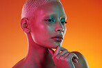 Neon, beauty and portrait of woman thinking in face makeup and light in creative advertising on orange background. Cyberpunk, art and model isolated in skincare and futuristic mockup space in studio.