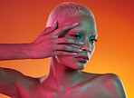 Neon, cosmetics and beauty, woman with hand in face, makeup and light in creative advertising on orange background. Cyberpunk, art and model isolated in skincare and futuristic mockup space in studio