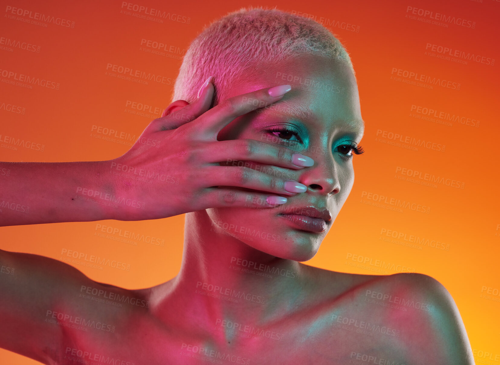 Buy stock photo Neon, cosmetics and beauty, woman with hand in face, makeup and light in creative advertising on orange background. Cyberpunk, art and model isolated in skincare and futuristic mockup space in studio