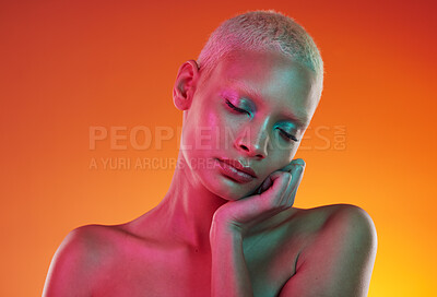 Buy stock photo Skincare, beauty and neon cosmetics, woman with face makeup and light in creative advertising on orange background. Cyberpunk, product placement and model isolated in future mockup space in studio.