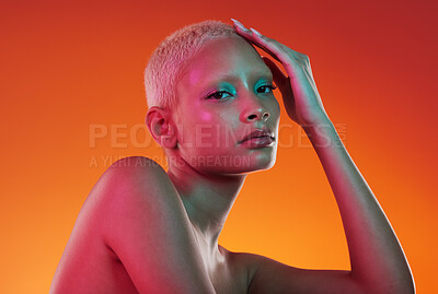 Buy stock photo Cosmetics, neon beauty and portrait of woman with makeup and light in creative advertising on orange background. Art, product placement and model isolated in skincare and futuristic mockup in studio.