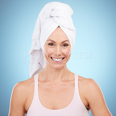 Buy stock photo Shower towel, woman and portrait in studio, blue background and face beauty. Female model, hair cloth and clean skincare for aesthetic, dermatology and happy spa for facial wellness, salon and smile