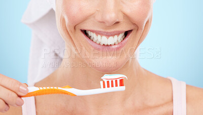 Buy stock photo Closeup of woman, smile and toothbrush isolated on a blue background for dental or orthodontics health. Beauty model or person mouth, brushing teeth with toothbrush product and toothpaste in studio