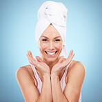 Portrait, skincare and woman with towel, smile and dermatology against blue studio background. Face detox. female and lady with washing, cleaning and hygiene with happiness, morning routine and relax