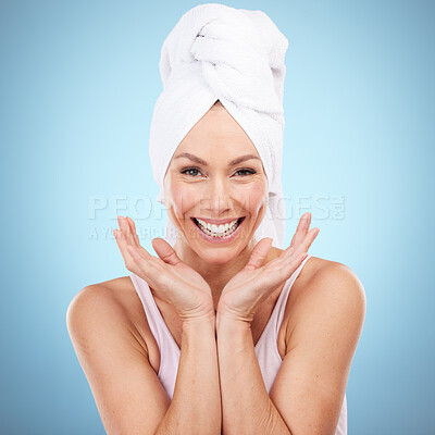 Buy stock photo Portrait, skincare and woman with towel, smile and dermatology against blue studio background. Face detox. female and lady with washing, cleaning and hygiene with happiness, morning routine and relax