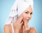 Portrait, shower towel and woman touch face in studio for beauty, dermatology or blue background. Female model, skincare and facial aesthetic of healthy shine, glow transformation and clean wellness