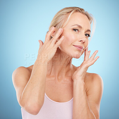 Buy stock photo Woman touch face for beauty, skincare and blue background for wellness, cosmetics and salon spa results. Portrait, facial and studio model with healthy aesthetic, laser dermatology and natural shine 