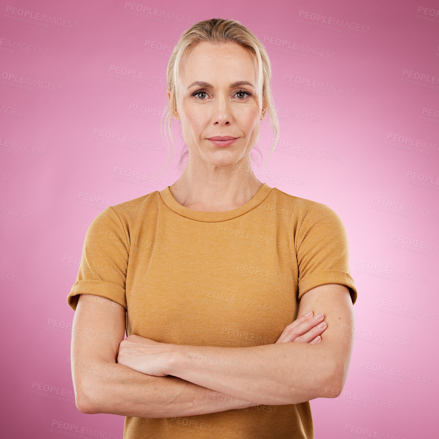 Buy stock photo Portrait, serious and woman with arms crossed on pink background, studio and backdrop color in Canada. Mature female model, focus and confidence of women empowerment, leadership and mindset of vision