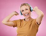 Music, dance and freedom with a woman in studio on a pink background for crazy fun or cheerful positivity. Party, energy and radio with a person streaming audio while dancing on a pastel color wall