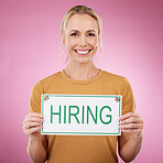 Woman, hiring sign and studio portrait, announcement or human resources on pink background. Happy female model advertising job hire, opportunity and signage for recruitment, work application or offer