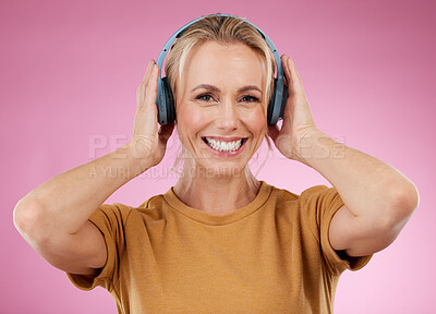 Buy stock photo Headphones, woman and portrait on pink background, wall backdrop or studio mockup. Happy female model listening to music, sound media and streaming audio connection, face and hearing podcast on radio