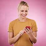 Woman, phone and typing online for communication, social media and online chat on pink background. Happy model person with smartphone hands for network connection or typing post on mobile app website