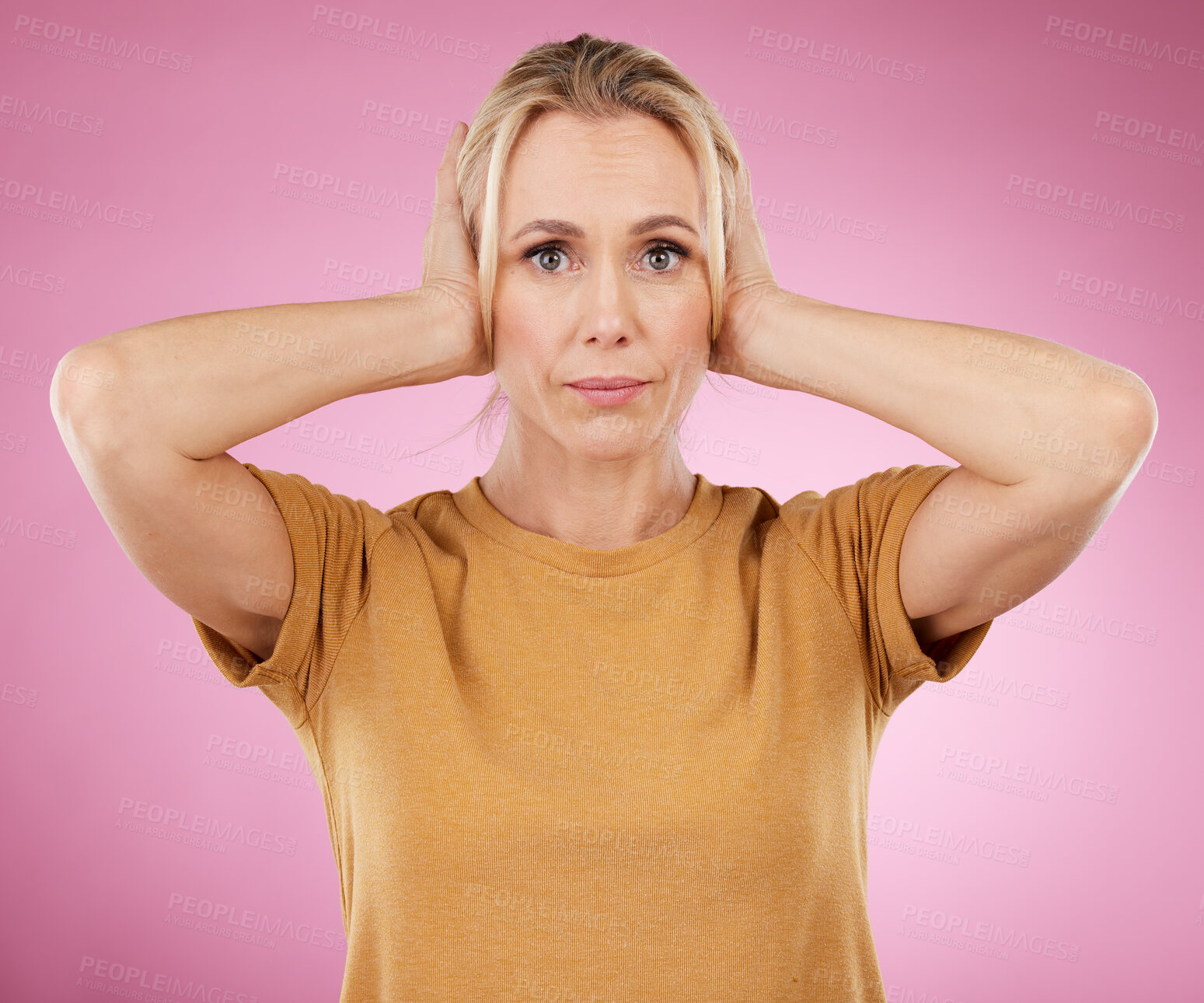 Buy stock photo Stress, loud and portrait of a woman with a problem isolated on a pink background in a studio. Sound, frustrated and mature person covering and blocking ears from noise for silence on a backdrop