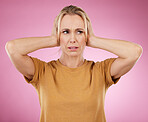 Loud, studio and woman closing her ears in a studio for noise distraction, sound or complaint. Upset, mad and annoyed female model with a hands on her head for cover isolated by a pink background.