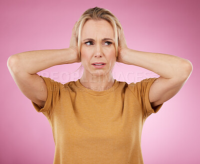 Buy stock photo Loud, studio and woman closing her ears in a studio for noise distraction, sound or complaint. Upset, mad and annoyed female model with a hands on her head for cover isolated by a pink background.
