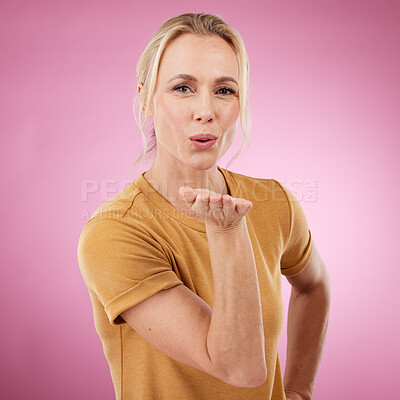 Buy stock photo Portrait, woman and blowing kiss on pink background for love, care and flirting lips on color backdrop in studio. Female model, hand kisses and expression of happiness, romance and kissing face emoji