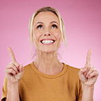 Mockup, woman and pointing on pink background, studio offer and advertising space. Happy female model, marketing and product placement of promotion, announcement and commercial mockup, news or review