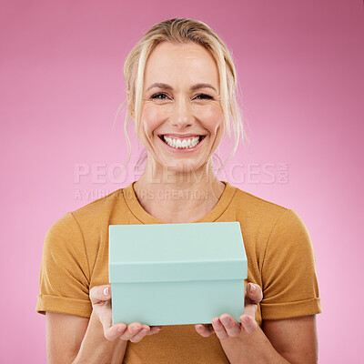 Buy stock photo Portrait, gift and old woman with smile, excited and cheerful with celebration against studio background. Face, mature female and senior lady with box, package and present with happiness and backdrop