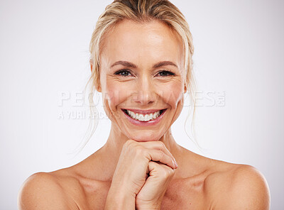 Buy stock photo Portrait, skincare and smile with a woman in studio on a gray background for beauty or antiaging treatment. Face, wellness and happy with an attractive female in the bathroom for a natural aesthetic