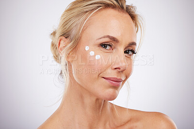 Buy stock photo Portrait, skincare and face cream for mature woman in studio for wellness, hydration and care on grey background. facial, product or sunscreen for lady relax in luxury, cosmetic and moisture isolated