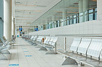 Empty airport, terminal lounge and chair furniture in waiting room of departure, global travel or transportation. Airplane lobby, seat and space of commercial flight, building interior or backgrounds