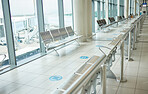 Airport, lounge chairs and terminal waiting room for global travel, covid regulations or immigration journey. Empty airplane lobby, seat or space of commercial flight, building interior or background