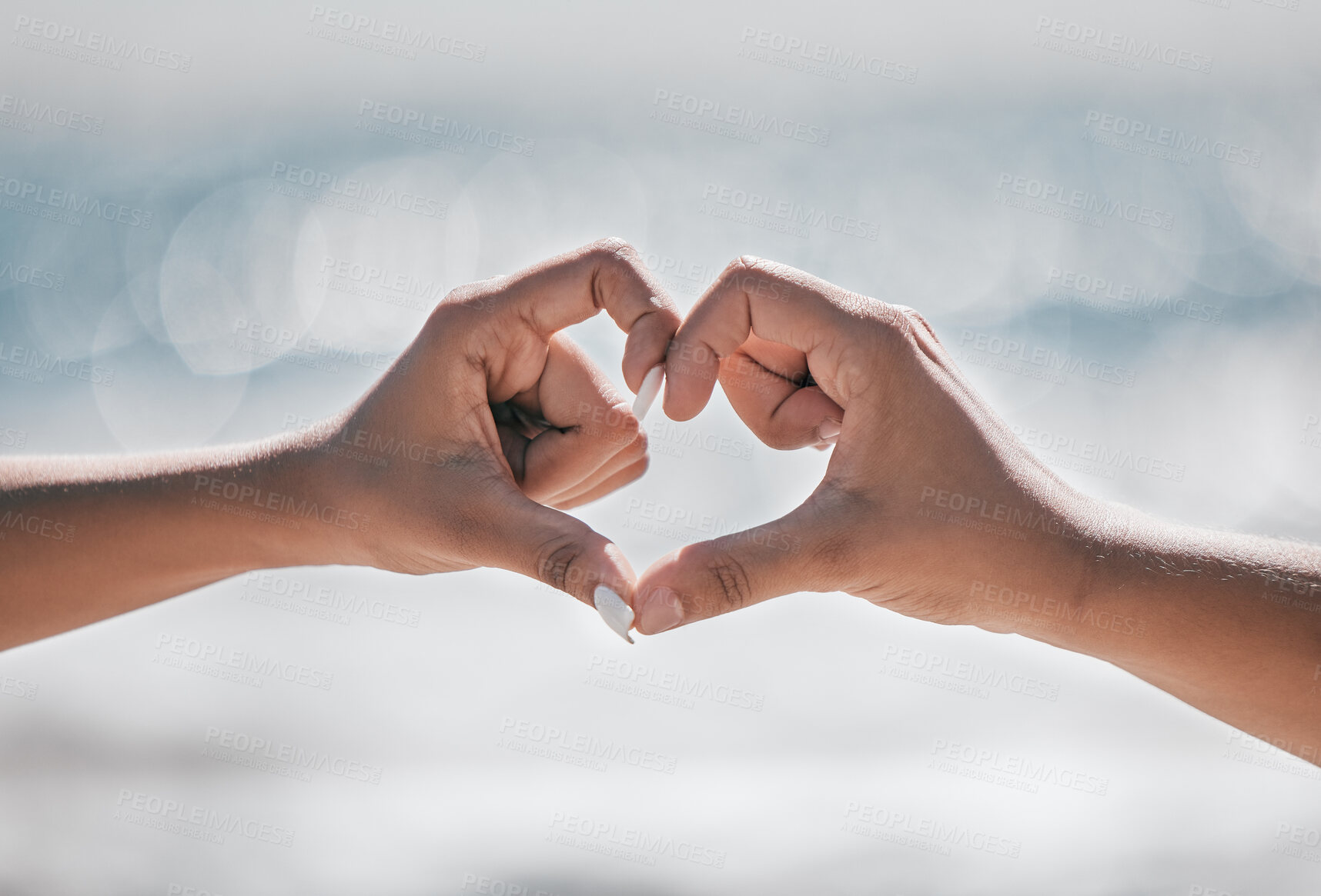 Buy stock photo Hands, heart and couple with love, peace and unity sign on mockup, space or blurred background. Hand, emoji and finger shape by man and woman at a beach for travel, vacation or summer trip in Bali