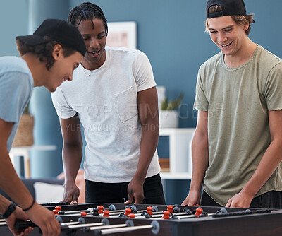 Buy stock photo Student foosball, friends and men playing a game at students accommodation at university. Board, soccer and guys with happiness and fun competition together in a lounge playing on sports table