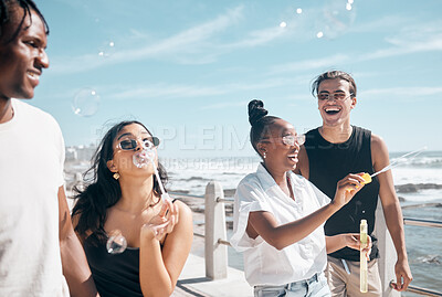 Buy stock photo Bubble, beach and summer with friends walking outdoor together on the promenade during vacation. Nature, diversity and freedom with a group of people bonding outside by the ocean or sea on holiday