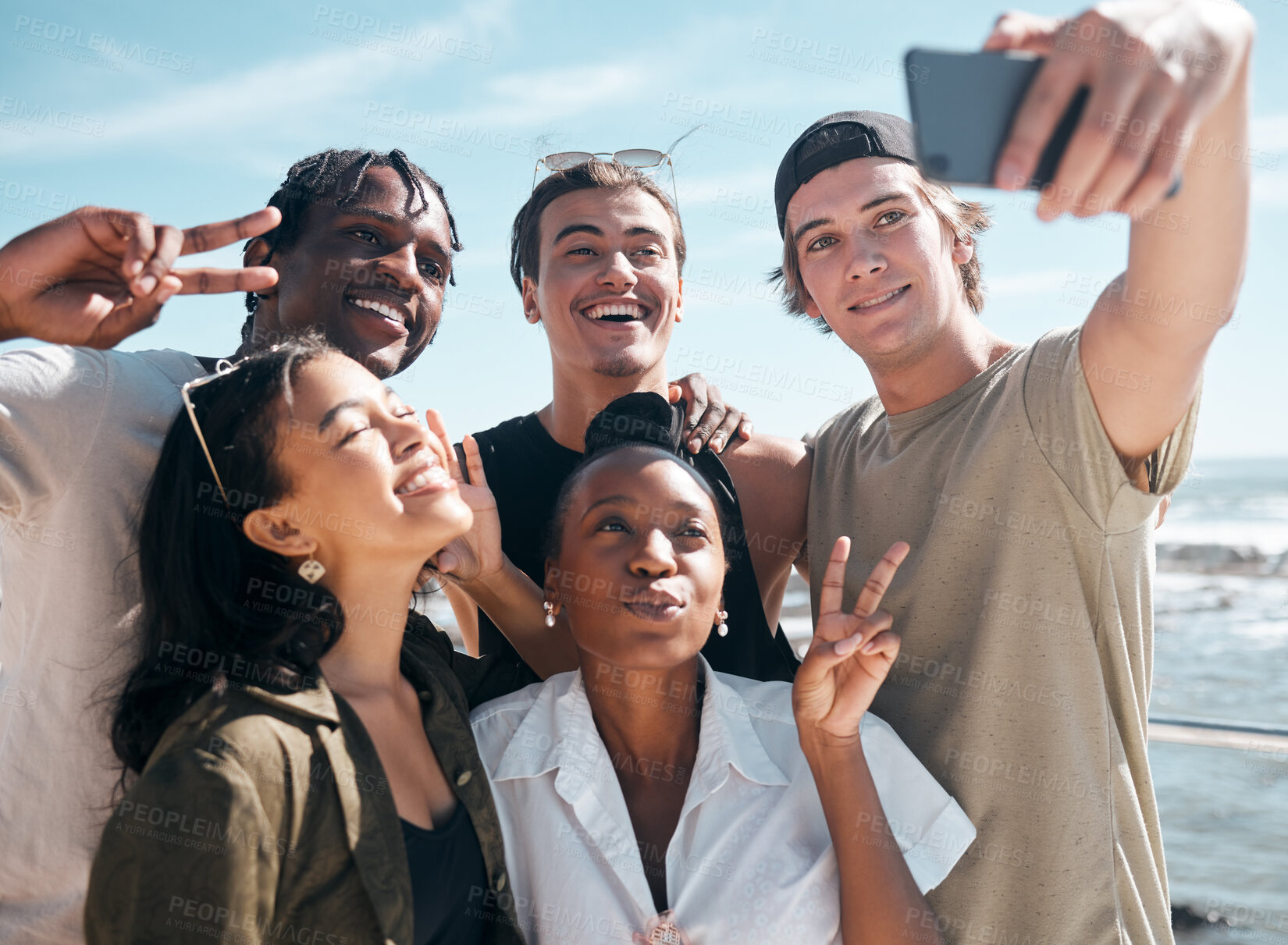 Buy stock photo Peace sign, friends and selfie of people at beach, having fun and enjoying vacation time outdoors. Travel, freedom or group of happy men and women with v hand gesture taking pictures for social media