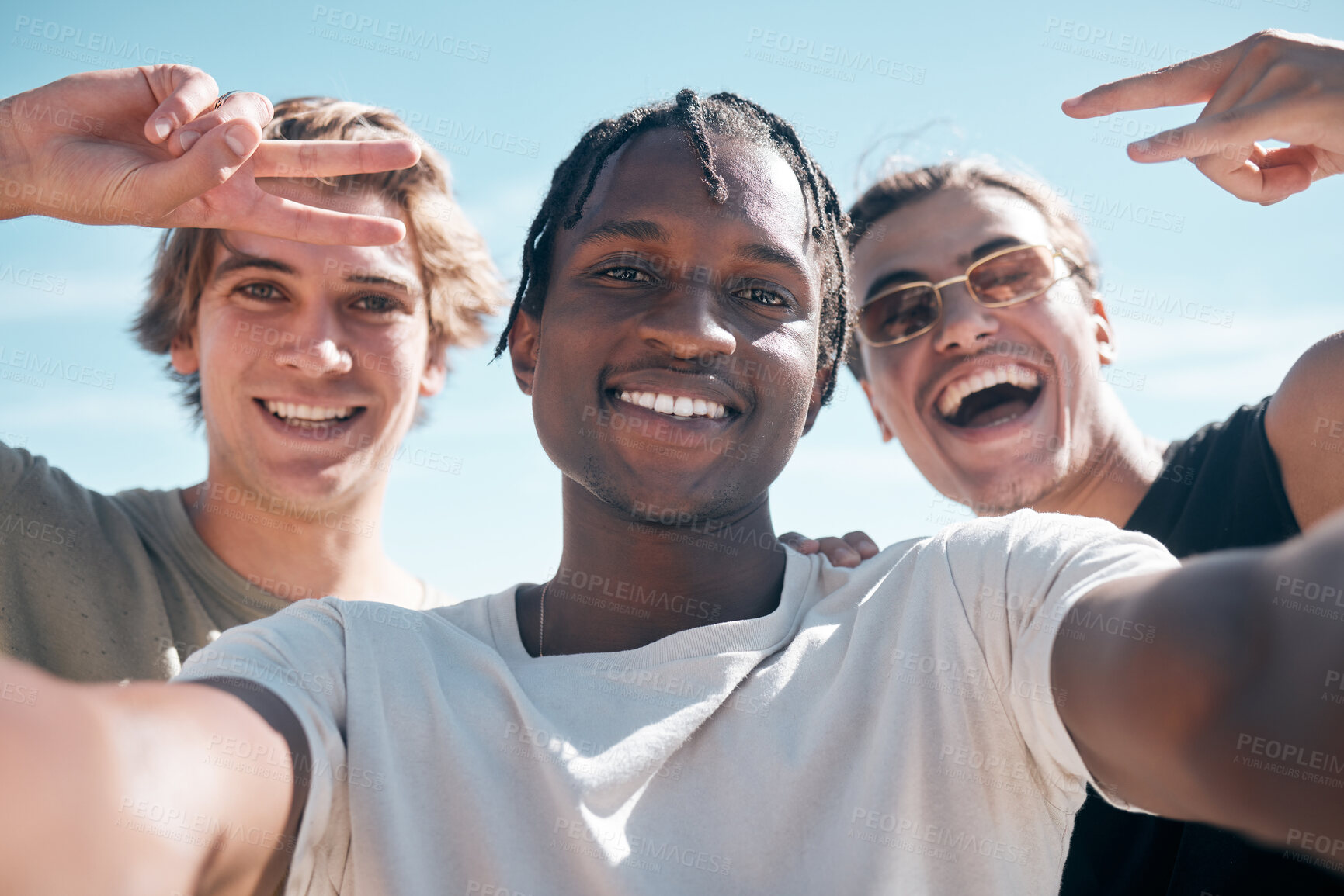 Buy stock photo Selfie, diversity and portrait of male friends on a summer vacation, weekend trip or adventure. Happy, sky and multiracial men with a smile taking picture with hand gestures while on holiday together