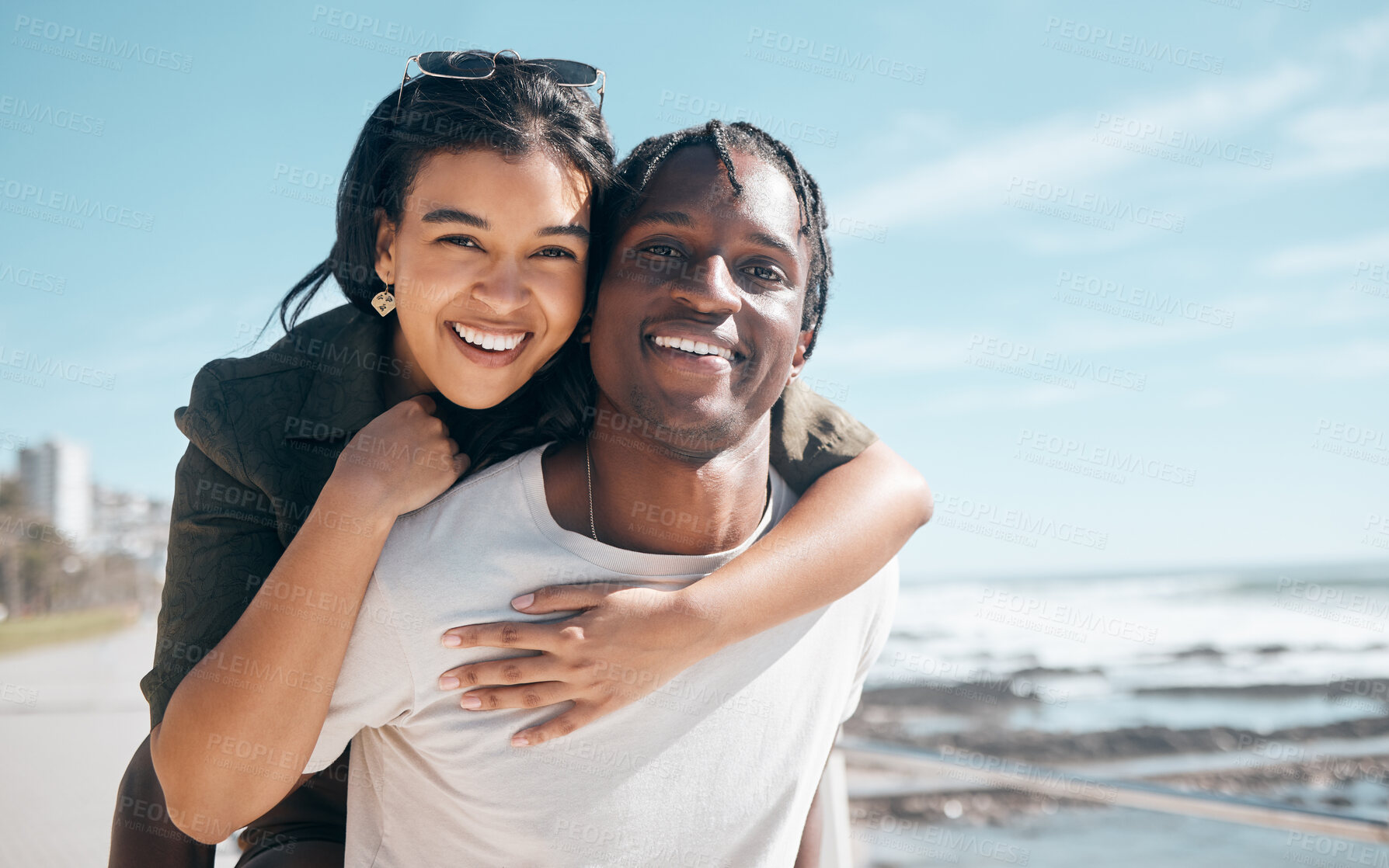 Buy stock photo Bonding couple, portrait or piggyback by beach, ocean or sea in relax mock up holiday, love vacation or summer travel. Smile, happy or man carrying black woman in fun game, freedom trust or support